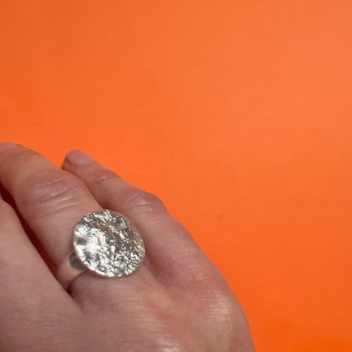 Silver reticulated moon ring on hand 