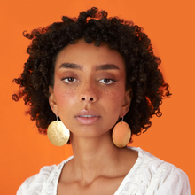 Load image into Gallery viewer, Model wearing supermoon earrings with orange background
